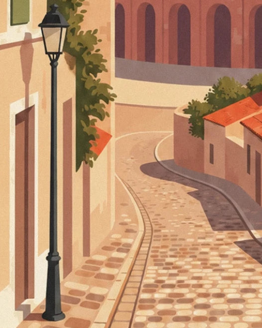 La ruelle pavée en courbe, son réverbère noir et ses façades ensoleillées
