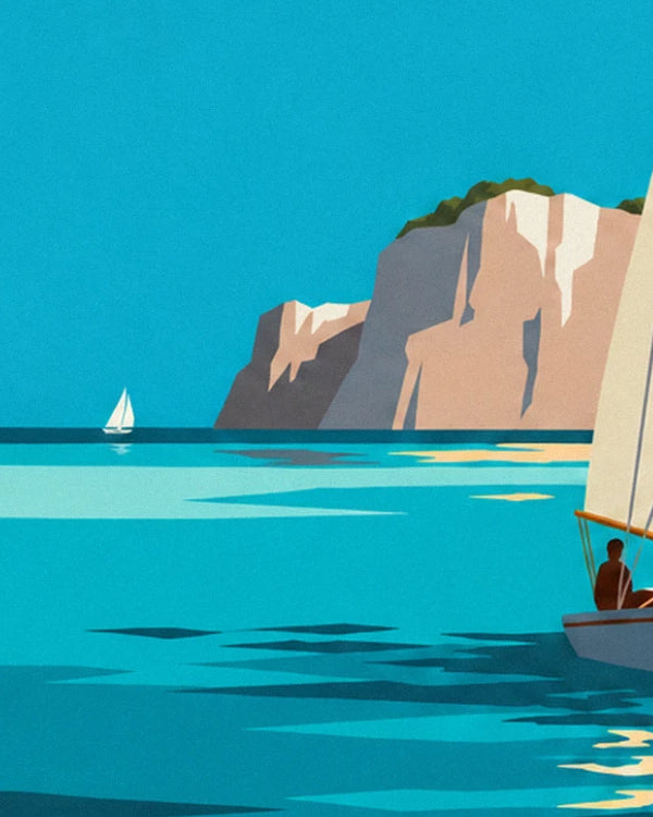 A small white sailing boat offshore, facing the beige cliffs and turquoise sea