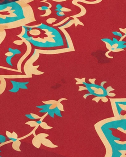 Turquoise and cream flowers with winding stems on the red rug