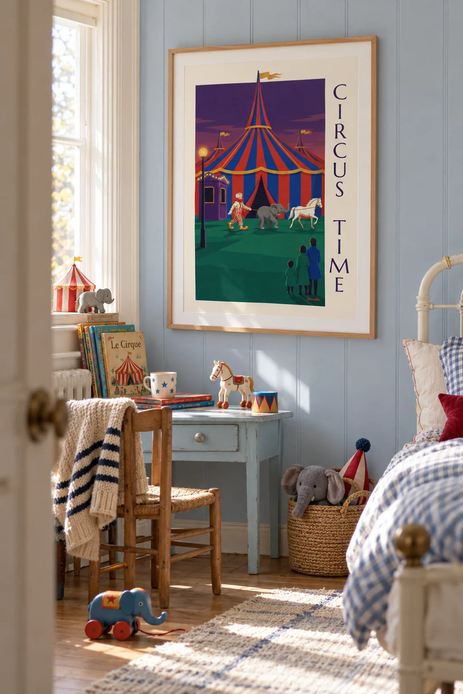 Poster of a clown, a baby elephant and a white horse in front of the big top: framed on the wall
