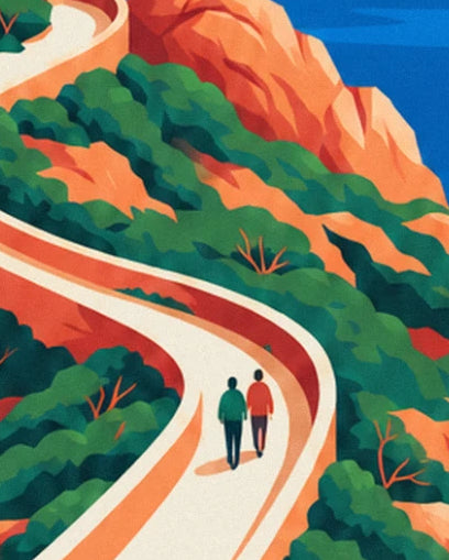 A couple walking along the pale path between orange rocks and green scrub