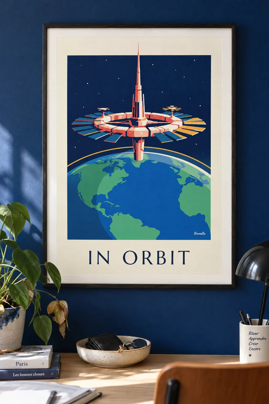 Poster of a space station orbiting the Earth: framed on the wall