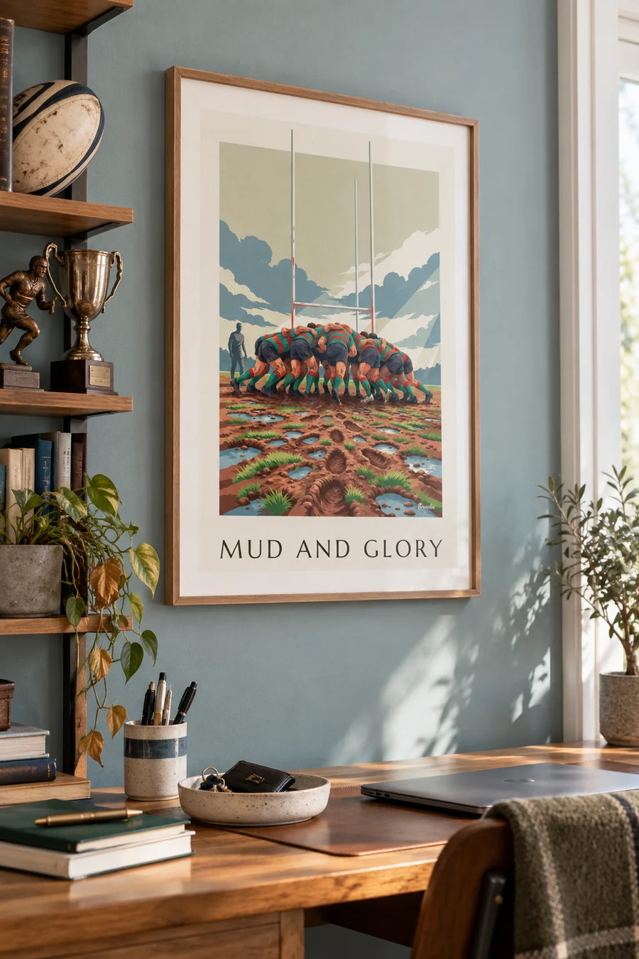 Poster of a rugby scrum in the mud under a rainy sky: framed on the wall