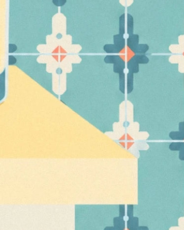 The yellow corner of the table in front of turquoise tiles with geometric patterns