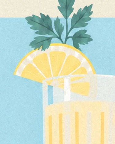A lemon slice on the rim of the glass of juice, beneath green leaves