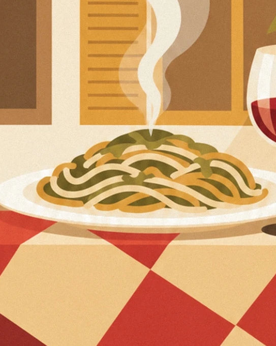 A plate of steaming spaghetti on a red and cream checked tablecloth
