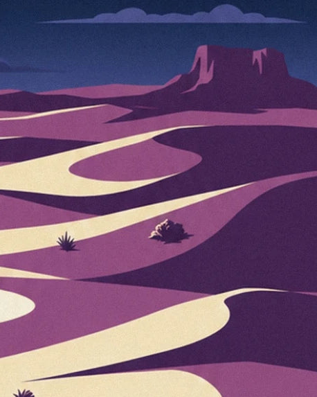 The mauve and cream desert dunes dotted with bushes at the foot of a rocky plateau