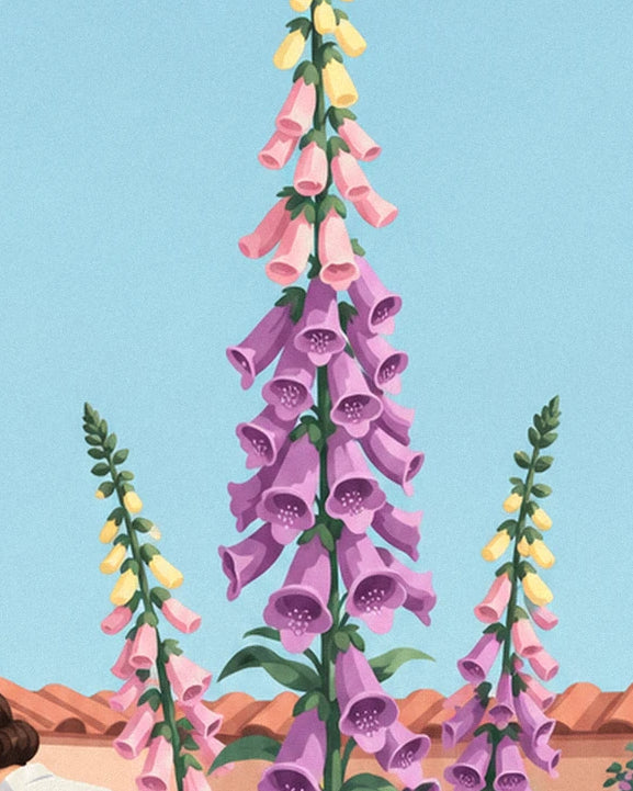 A tall purple foxglove with pink and yellow bells, against a blue sky and tiled roof
