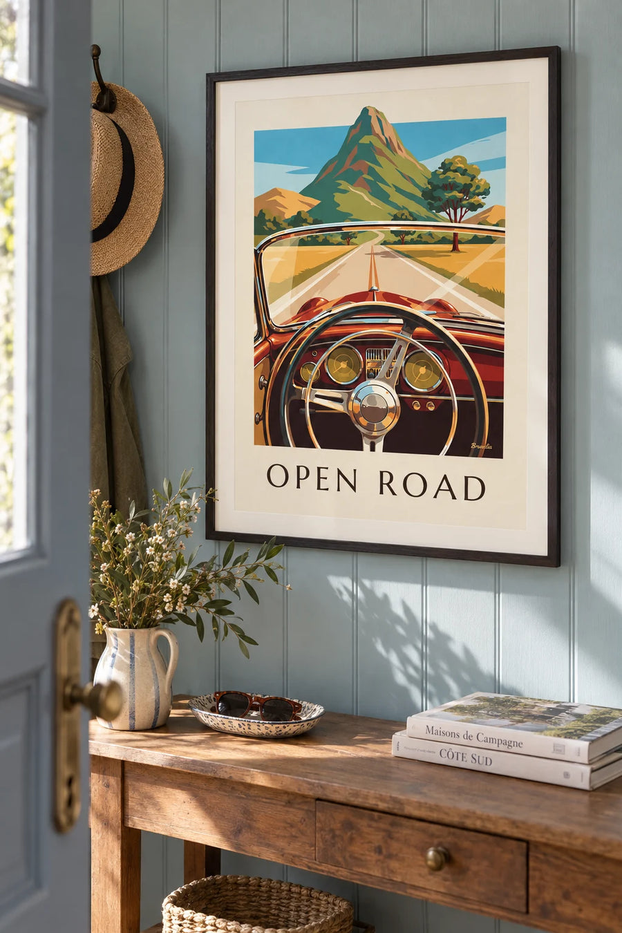 Poster of a road and the dashboard of a classic car: framed on the wall