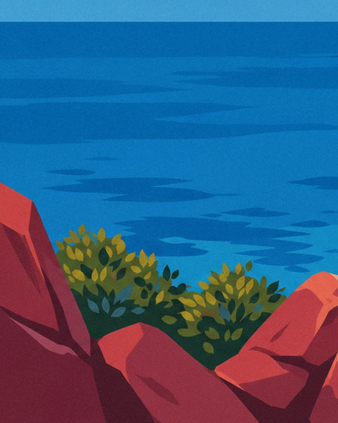 La mer d'un bleu intense vue des rochers rouges, avec 2 touffes de buissons verts