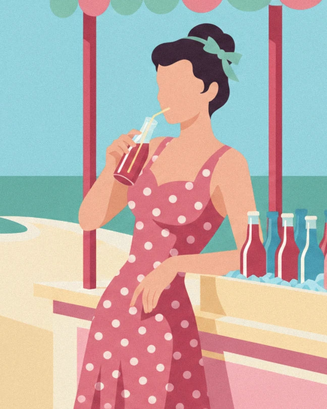 The pin-up in a pink dress with white polka dots, holding a bottle with a straw to her lips