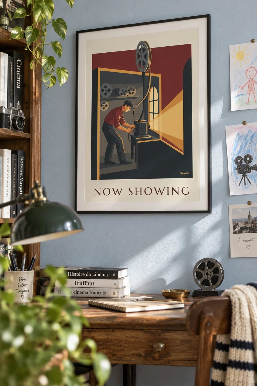 Poster of a cinema projectionist and film reel: framed on the wall