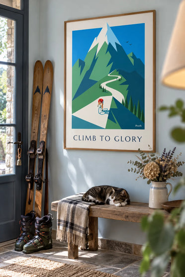 Poster of a cyclist climbing a winding mountain pass: framed on the wall