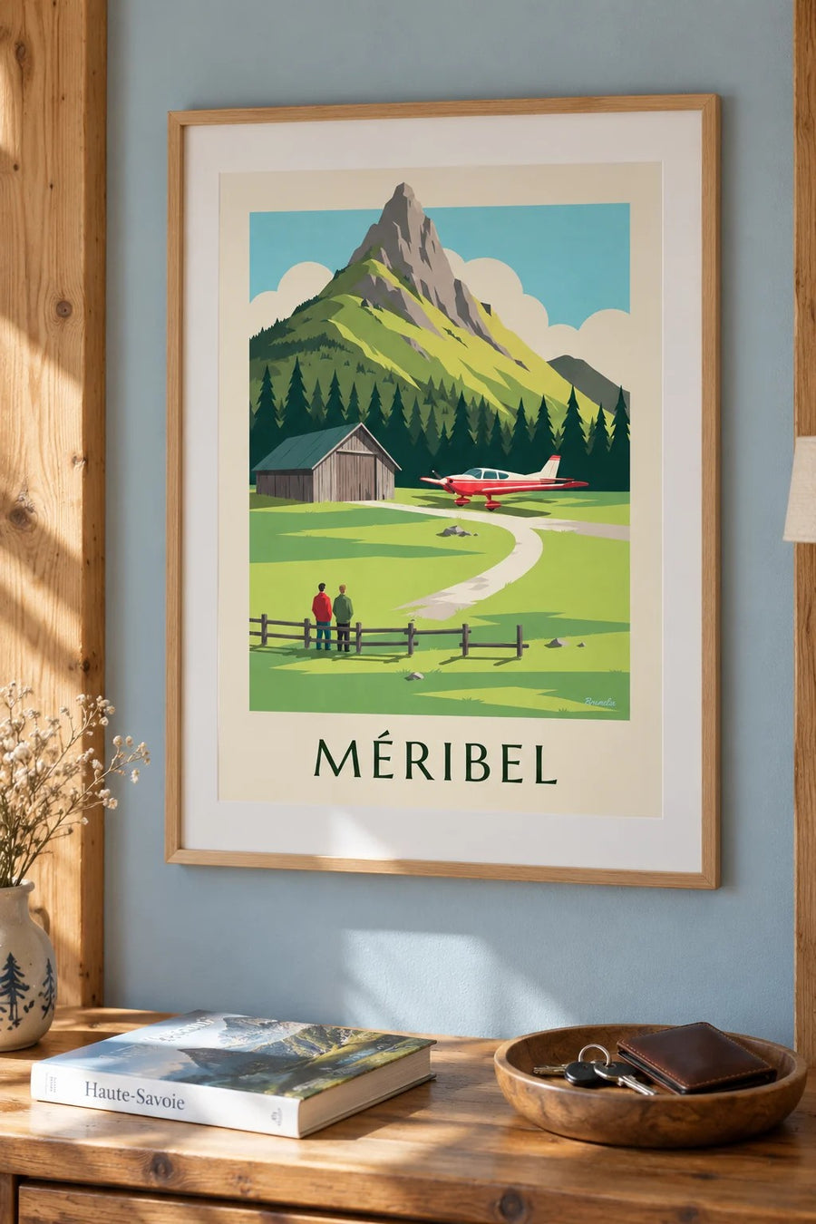 Plakat med Méribel og lille fly ved højfjeldslufthavnen : indrammet på væggen