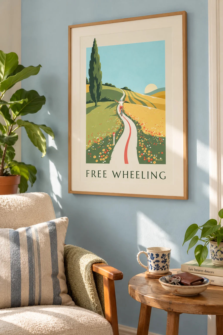 Poster of a cyclist with arms wide open on a road through flowering hills: framed on the wall