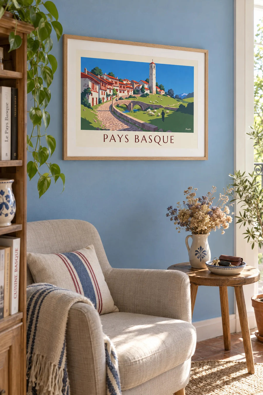 Poster of a Basque village with half-timbered houses and sheep: framed on a wall