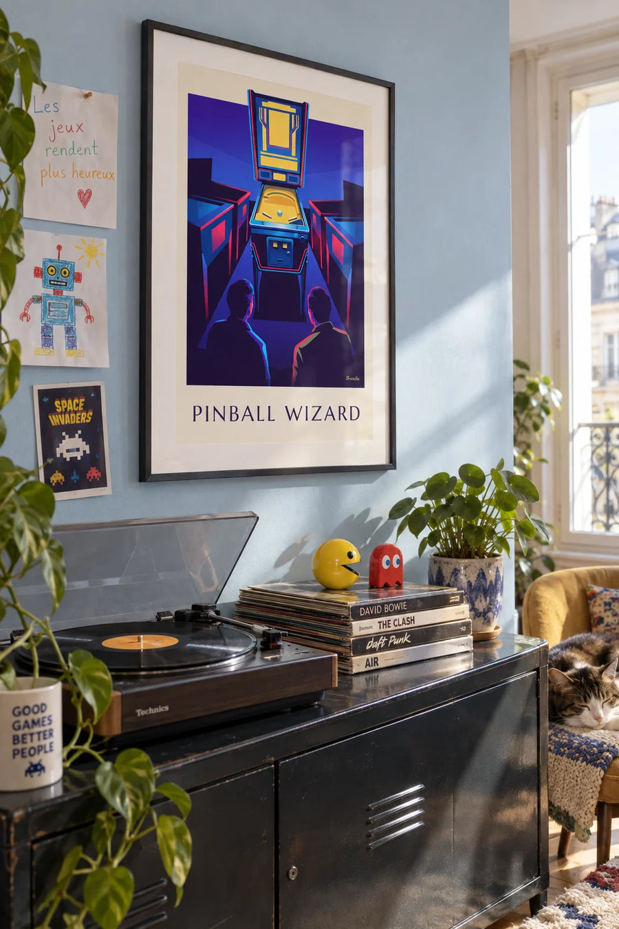 Poster of a neon-lit pinball machine in an arcade: framed on the wall