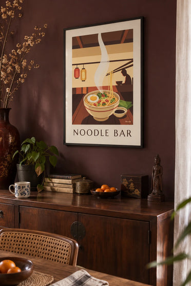 Poster of a steaming bowl of Asian noodles and chopsticks: framed on the wall
