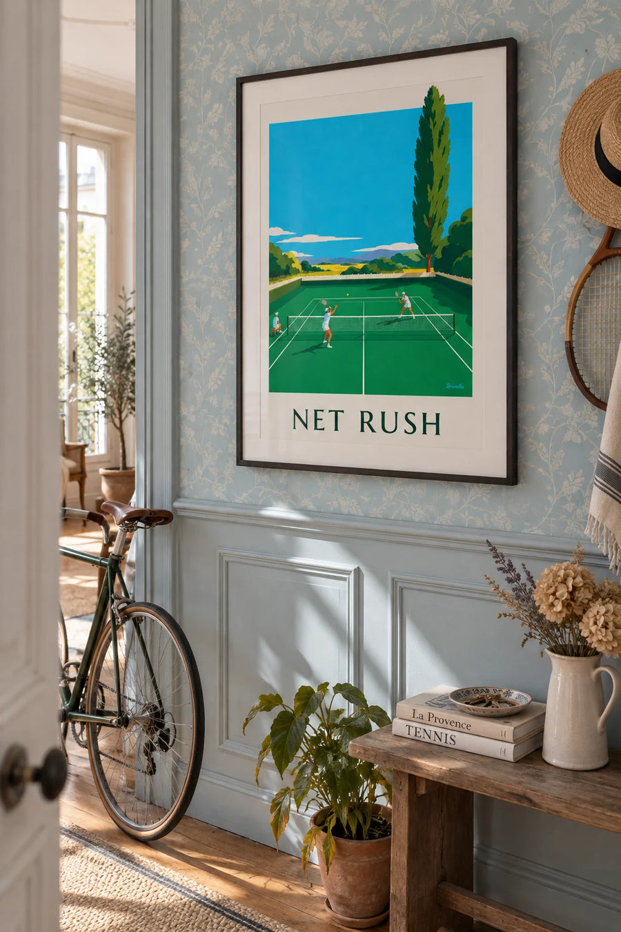 Poster of a tennis player volleying at the net on a grass court: framed on the wall