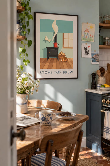 Poster of an enamel coffee pot on a kitchen wood stove: framed on the wall